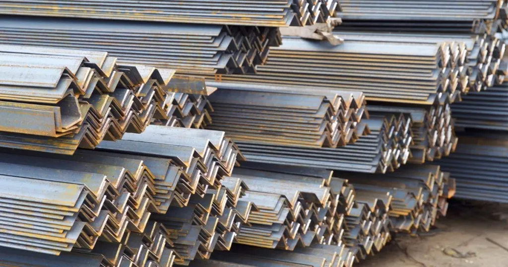 Stacks of rolled steel angles stored in a yard