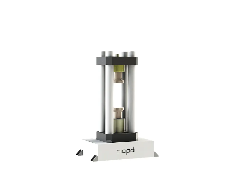 Biopdi four-column hydraulic press with a cylindrical test specimen between the compression platens